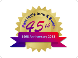 A gold seal with the words east hill 's inns & suites 4 5 th anniversary 2 0 1 3.