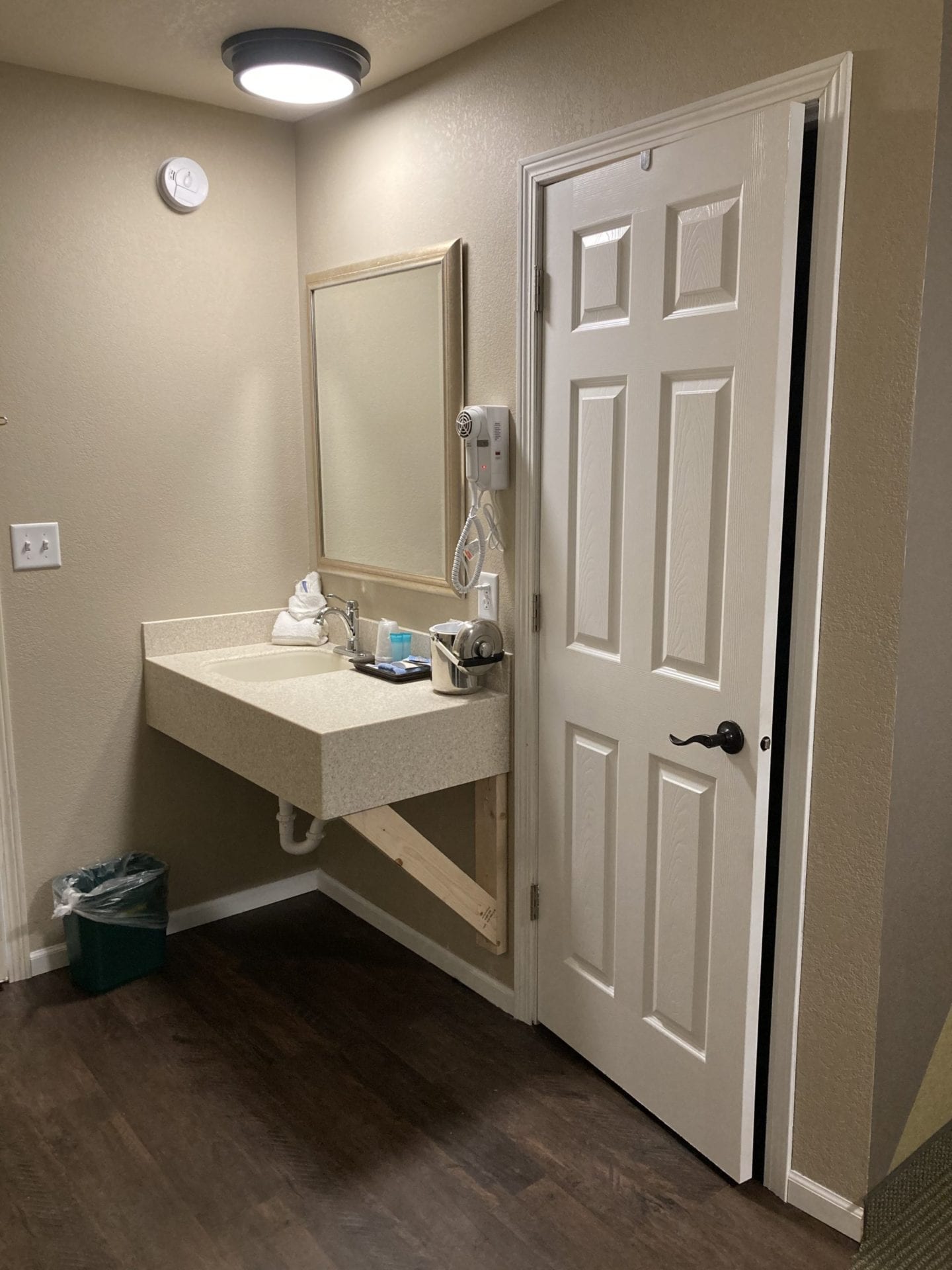 A bathroom with a sink and mirror in it